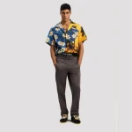 Model wearing Palm Angels Curved Logo Track Pants styled with sneakers