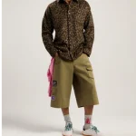 Model wearing Palm Angels Military Patch Bermuda Shorts front view